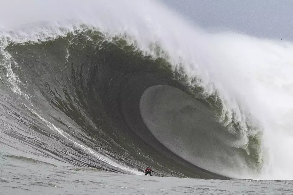 Alo Slebir surfs a 108 foot wave at Mavericks in Half Moon Bay, Calif., on Dec. 23, 2024.webp
